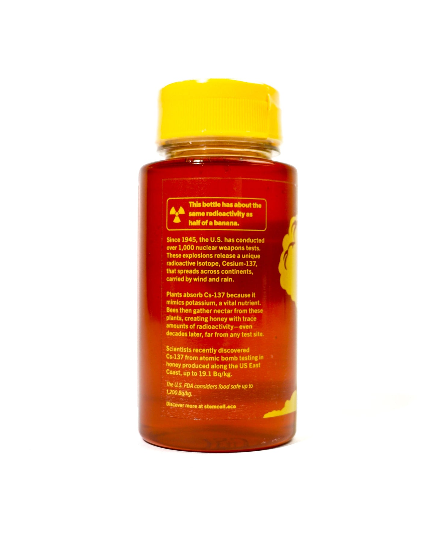 Bottle of honey with a yellow cap on a white background