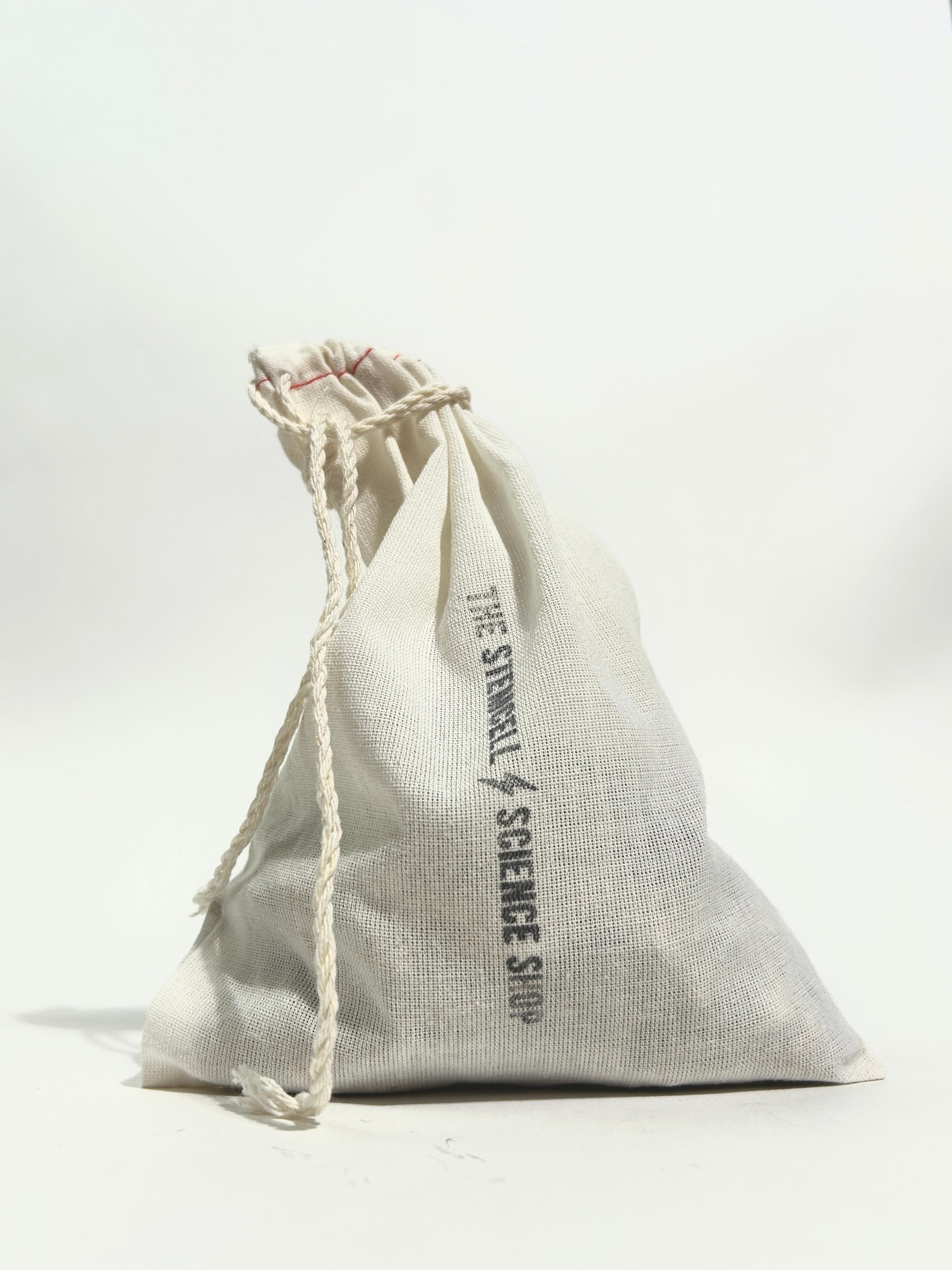 A small off-white canvas drawstring pouch with a printed vertical logo reading 'THE STEMCELL SCIENCE SHOP' on a clean white background.
