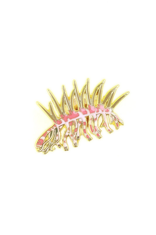 Gold hair comb with pink center on a white background